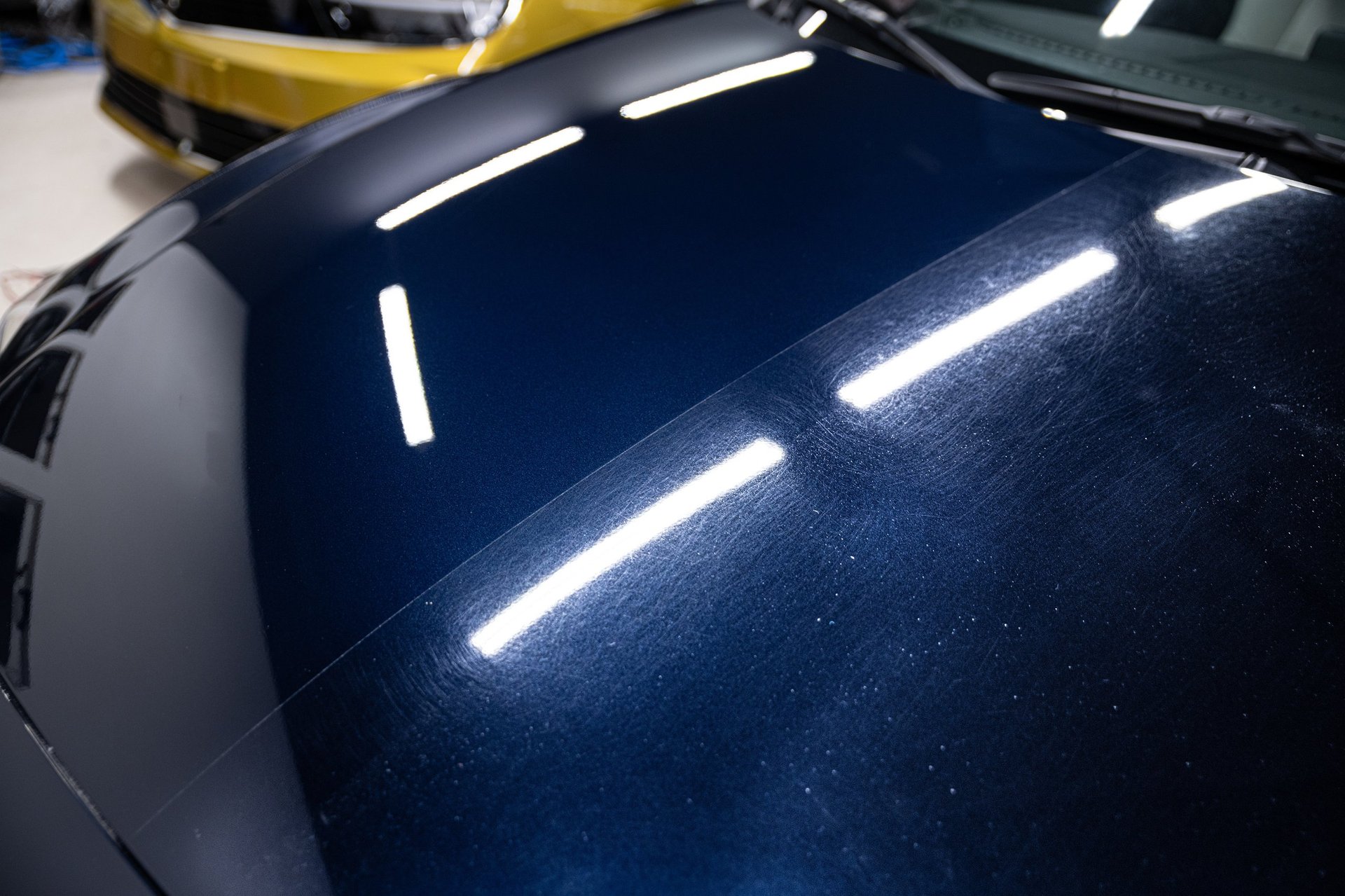 One hood, half corrected — mirror left, swirls right